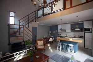 a kitchen and a living room with a loft at Culemborg Cottage in Cape Town