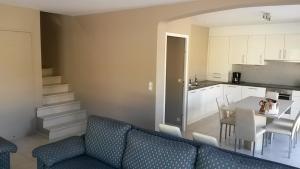 a living room with a couch and a table and a kitchen at villa-castellane in Castellane