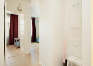 a white room with a hallway with a mirror at Kalamehe Apartment 4 near City center in Pärnu +80 photos