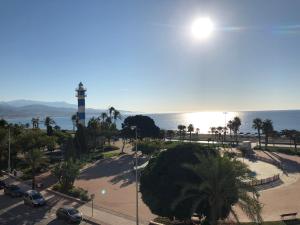 un faro en un parque junto al océano en Vistamar Beach Luxury - 1ª Línea De Playa En Torre del Mar, Piscina y Apartamiento, en Torre del Mar