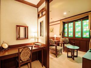 a home office with a desk and chairs and a window at Kanazawa Hakuchoro Hotel Sanraku -Natural Hot Spring- in Kanazawa