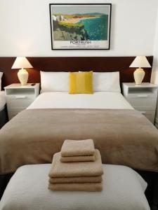 a bedroom with a large bed with two night stands at Malvern House in Portrush
