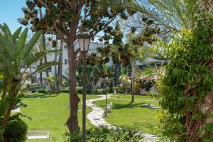 a park with a pathway and trees and a street light at Apartamento Marbella Real 2D in Marbella