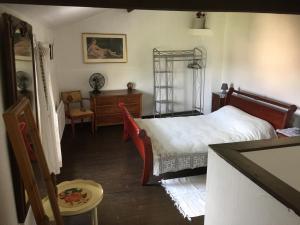 a bedroom with a bed and a desk and a chair at Gite a la campagne in Sardent