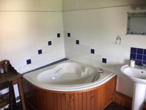 a bath tub in a bathroom with a sink at Gite a la campagne in Sardent +11 photos