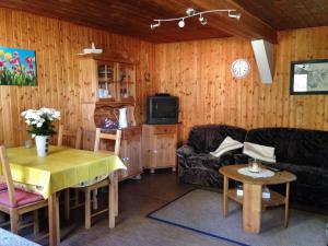 a living room with a couch and a table at Reiterhof Winandy in Wietzendorf