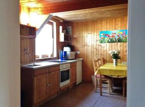 a small kitchen with a table and a yellow tableablish at Reiterhof Winandy in Wietzendorf