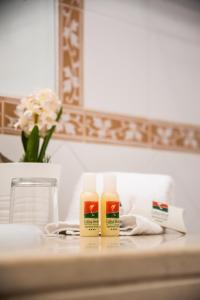 two bottles of medicine sitting on a bathroom counter at Colina Verde Resort in Moncarapacho