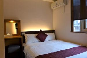 Postel nebo postele na pokoji v ubytování Chiu Chunt Dint B&B