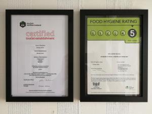 two framed menus are hanging on a wall at Malvern House in Portrush