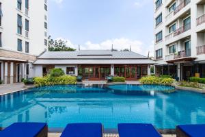 a swimming pool in the middle of a building at Lasalle Suites Hotel & Residence in Bangkok