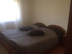 a bed in a bedroom with two pillows on it at Apartment Ejla in Medulin