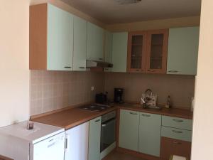 a kitchen with white cabinets and a stove top oven at Apartment Ejla in Medulin +2 photos