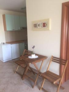 a kitchen with a wooden table and two chairs at Apartment Ejla in Medulin