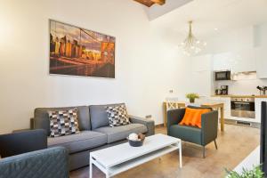 a living room with a couch and two chairs and a table at Stay U-nique Apartments Eixample Center in Barcelona
