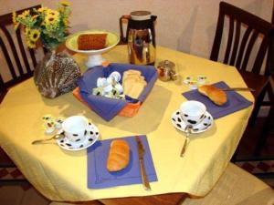 a table with a table set with food on it at B&B Teatro Bellini in Catania