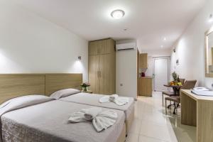 a bedroom with two white towels on a bed at Bellini Hotel in Ayia Napa