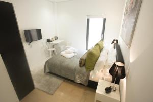 Un pequeño dormitorio blanco con una cama y una ventana. en Room Home Stay, en Londres