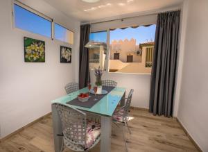 a dining room with a blue table and chairs at Apartamento Nerja Medina in Nerja