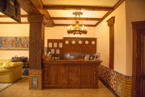 a lobby with a bar in a house with a chandelier at Platan in Samarkand