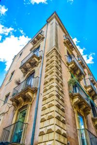 a tall building with balconies on the side of it at The Artist's Home Catania Centro in Catania