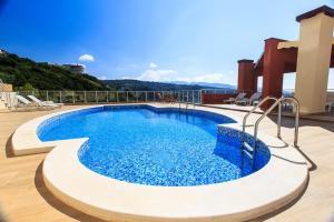 a swimming pool on top of a building at Apartments Sunny Marina in Dobra Voda