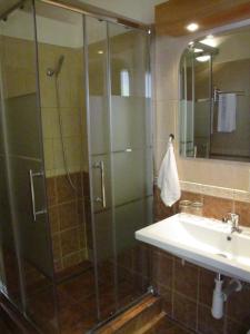 a bathroom with a shower and a sink at Hotel Hubert Nové Zámky in Nové Zámky