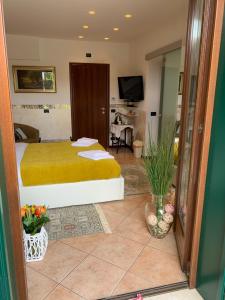 a hotel room with a bed and a television at B&B Garda 4U in Desenzano del Garda