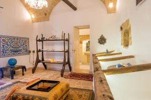 a room with two beds and a table in a room at Palazzo Tre Cardi in Salve