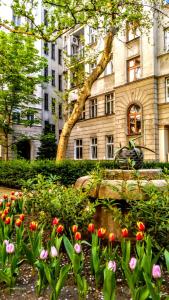 a garden of flowers in front of a building at Turul Apartment Budapest in Budapest