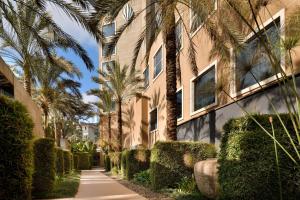 a sidewalk in front of a building with palm trees at Sankara Nairobi, Autograph Collection in Nairobi
