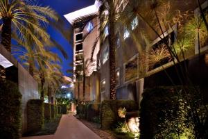 a walkway in front of a building with palm trees at Sankara Nairobi, Autograph Collection in Nairobi