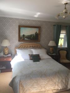 um quarto com uma cama grande e um livro sobre ele em Killyliss Country House B&B em Lisnalong