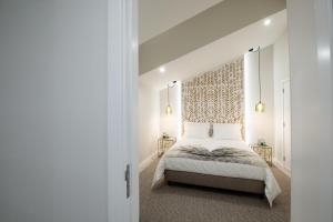 a bedroom with a bed and two side tables at House Rodrigues in Água de Pau +47 photos