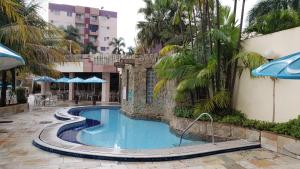 a swimming pool in the middle of a resort at Apartamento Caldas in Caldas Novas