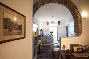 a living room with an archway and a dining room at Roman Holidays cuore dell'Impero in Rome
