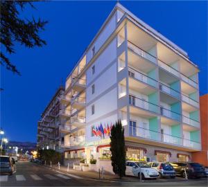a white building with cars parked in front of it at Hotel La Meridiana in Sorrento