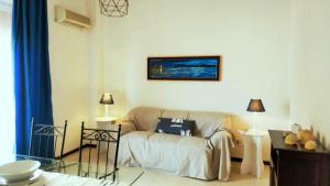 a living room with a couch and a table at Trapani Egadistar Apartments in Trapani