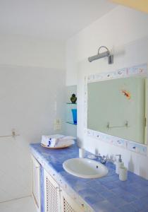 a bathroom with a sink and a mirror at Casa Acquamarina in Villanova di Ostuni