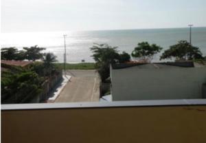 a view of the ocean from a balcony of a house at Pousada Brisa do Mar in Aracruz +25 photos