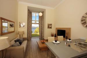 a living room with a couch and a table at 4 Lomond Castle in Balloch