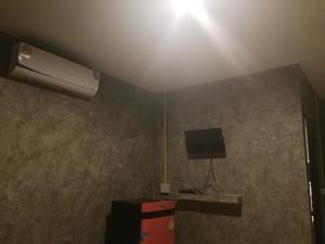 a room with a ceiling with a television and a ceiling light at Chill loft โฮมเสตย์ in Nan