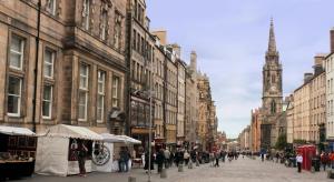 a group of people walking down a city street at Queen Street Boutique Suites in Edinburgh