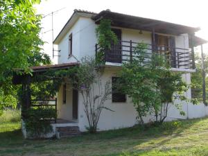 a white house with trees in front of it at Villa Mina in Potistika