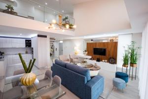a living room with a blue couch and a table at House Rodrigues in Água de Pau