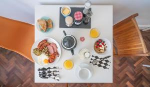 a table topped with plates of breakfast foods and eggs at Ty Ffynnon B&B in Tenby