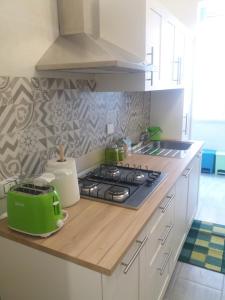 a kitchen with a stove and a green toaster on a counter at Pietro's house in Rome