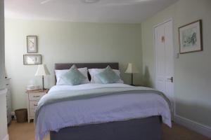 a bedroom with a large bed with purple sheets at Cherubs Nest in Dartmouth