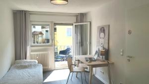 a bedroom with a desk with a laptop on it at Pforzheim Ferienhaus in Pforzheim