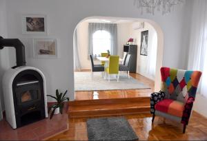 a living room with a fireplace and a table and chairs at My Day House App1 in Klenovica +34 photos